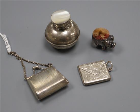 A miniature 925 purse. a silver pig pin cushion, marks rubbed, a 925 envelope stamp case and an Edwardian scent flask,